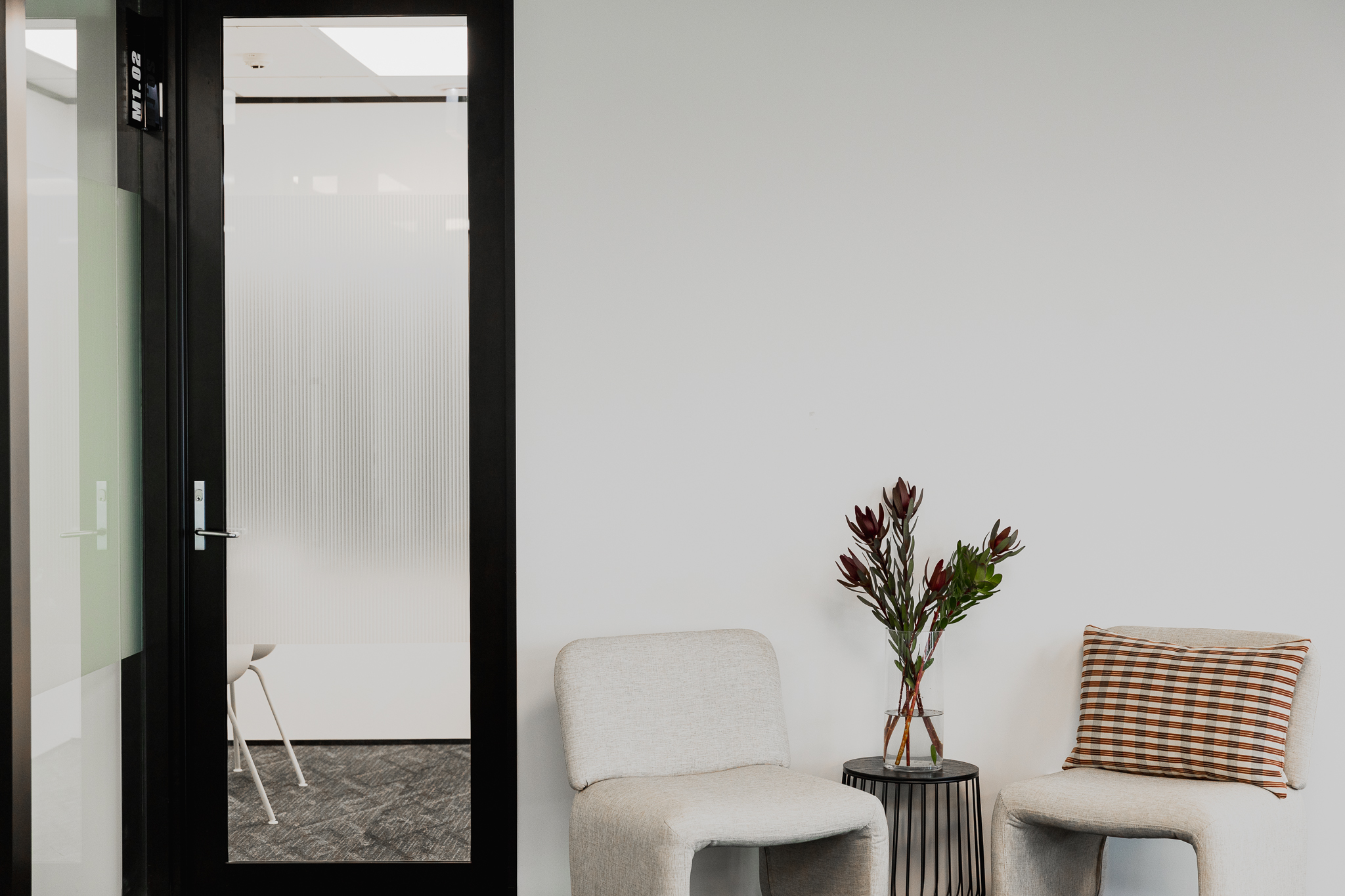 Private phone booth and lounge chairs at Q Space