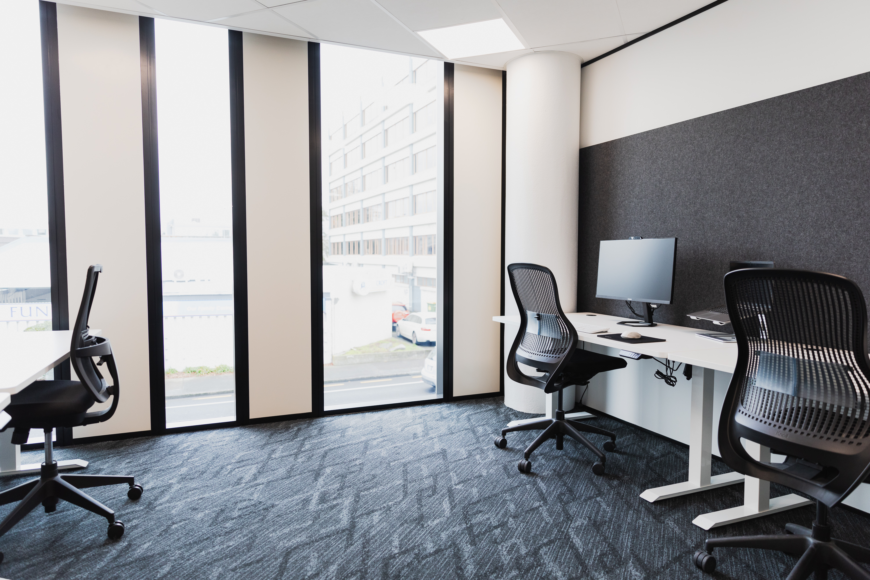 Private serviced office with desks and window light at Q Space